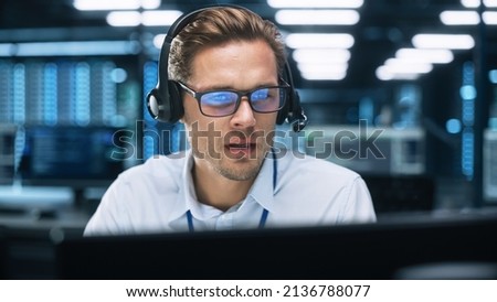 Call Center Worker Wearing Headset Working in Office to Support Remote Customer. Call Center, Telemarketing, Customer Support Agent Provide Service on Video Conference Call.