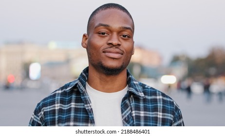 Call Me Sign. Calling Symbol. Positive African American Man Looking At Camera Playful Flirting Guy In City Holding Telephone Hand Gesture Near Ear Asking Offering Contact By Phone Standing On Street