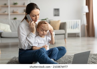 Call to pediatrician. Stressed mother talking to doctor, worried about her son's health, checking child's temperature by holding hand on kid forehead. Remote healthcare consultation.