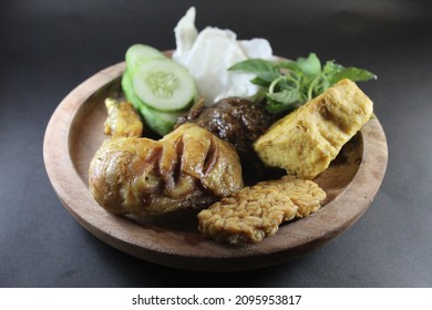 called pecel ayam in Indonesian, served with fried chicken, tempeh and tofu. added with fresh vegetables or lalapan in Indonesian such as basil, cucumber, and cabbage.