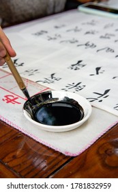 A Calligrapher Is Creating Calligraphy, Dipping A Brush Into Ink, Translation: Prajna Paramita Heart Sutra