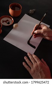 Calligraphy master work table with paper and pen