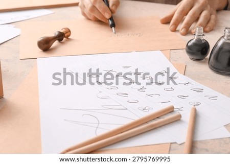 Calligraphy practice with ink and pen, learning elegant handwriting, creative lettering art, and traditional craft skills