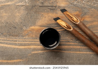 Calligraphy reeds covered ink with inkwell on wooden background. Reeds pen ink for writing Arabic calligraphy - Powered by Shutterstock