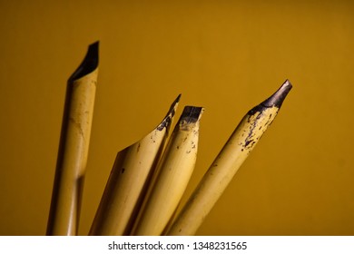 Calligraphy Reeds (qalam) Covered In Ink Against A Yellow Background