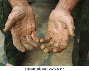 The calloused hands of an elderly man doing agricultural manual labor. Labor protection and agriculture. Social protection of handymen.