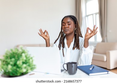 Calm African Female Executive Meditating Taking Break At Work For Mental Balance, Mindful Businesswoman Feeling Relief And No Stress Doing Yoga At Work Ignoring Avoiding Stressful Job