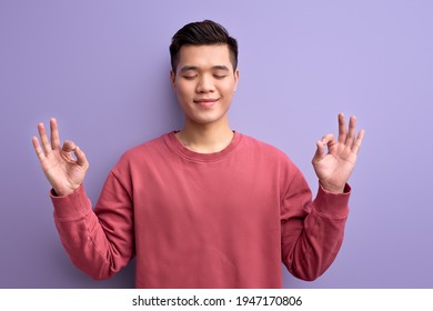 Calm Asian Male Meditating, Keep Calm In Yoga Pose With Eyes Closed