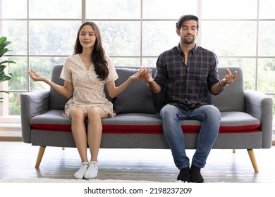 Calm Asian Woman And Caucasian Man Meditating Taking Break At Work For Mental Balance, Mindful Businessman And Woman Feeling Relief And No Stress Doing Yoga At Work. Work Life Balance Concept.