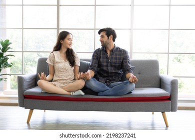 Calm Asian Woman And Caucasian Man Meditating Taking Break At Work For Mental Balance, Mindful Businessman And Woman Feeling Relief And No Stress Doing Yoga At Work. Work Life Balance Concept.