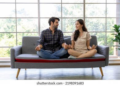 Calm Asian Woman And Caucasian Man Meditating Taking Break At Work For Mental Balance, Mindful Businessman And Woman Feeling Relief And No Stress Doing Yoga At Work. Work Life Balance Concept.