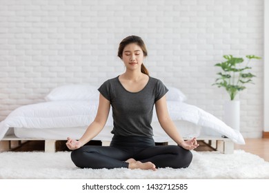 Calm of Attractive Asian woman practice yoga lotus pose to meditation in bedroom after wake up in the morning Feeling so comfortable and relax,Healthcare Concept - Shutterstock ID 1432712585