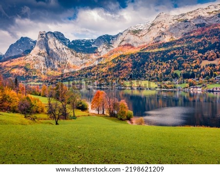 Calm autumn view of Grundlsee lake with huge mountain range on background. Colorful morning scene of Brauhof village, Styria stare of Austria, Europe. Traveling concept background.
