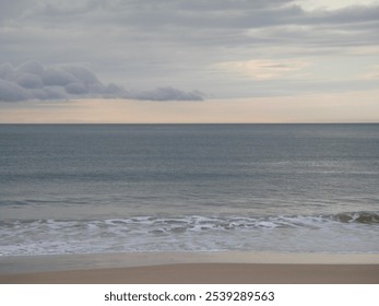 Calm beach on a cloudy day. - Powered by Shutterstock