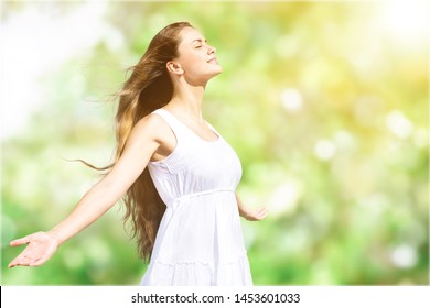 Calm beautiful smiling young woman with ponytail enjoying fresh air outdoor, relaxing with eyes closed, feeling alive, breathing, dreaming. Copy space, green park nature background. Side view portrait - Shutterstock ID 1453601033
