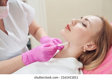 Calm beautiful woman during the preparing her neck before the beauty procedure