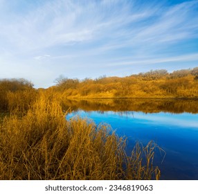 calm blue river under cloudy sky - Powered by Shutterstock