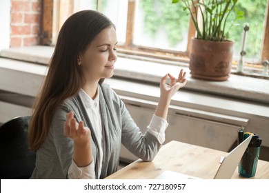 Calm Businesswoman Meditating In Yoga Pose In Modern Office Setting. Business Lady Taking Care Of Her Health During Break. Reducing Discomfort At Workplace, Staying In Focus, Stress Relief At Work. 