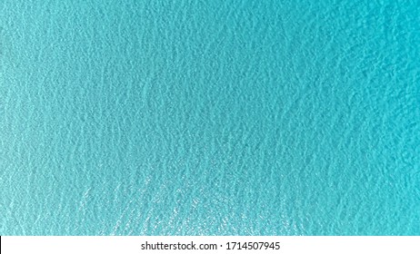 Calm clear blue sea water background. Blue azure sea water texture. 
