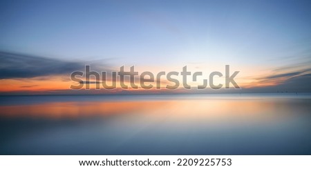 Calm colored sea and sky at sunset. Long exposure, panoramic view