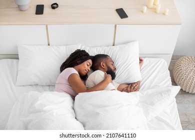 Calm Cute Peaceful Young African American Woman Hugs Man And Sleeps On Comfort Bed Together In Bedroom, Profile, Top View. Love, Family, Relationships And Healthy Sleep At Home, Rest And Relaxation