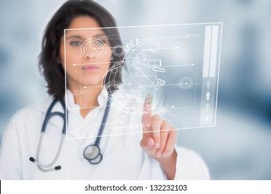 Calm doctor touching a medical interface in the hospital - Powered by Shutterstock