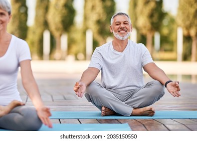 Calm Elderly Retired Family Couple Practicing Yoga Outside Happy Husband And Wife Sitting On Mats Barefoot With Eyes Closed In In Lotus Pose With Hands In Mudra Gesture . Meditation And Mental Health