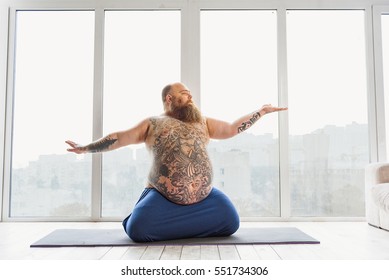 Calm Fat Man Meditating Near Window Calm Fat Man Meditating Near Window