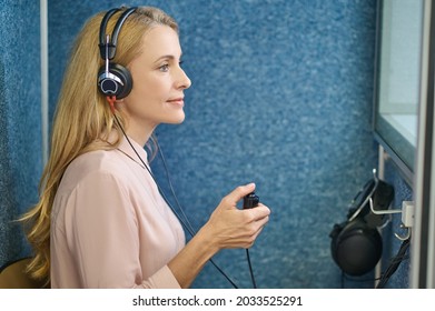 Calm Female Patient Undergoing A Hearing Test At A Clinic