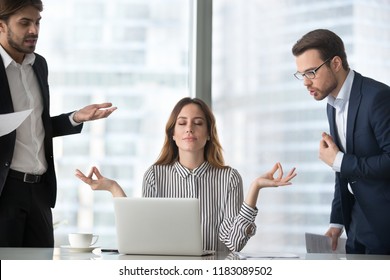 Calm Female Worker Meditate At Workplace Managing Stress Not Paying Attention To Angry Colleagues, Businesswoman Sitting In Lotus Pose Practicing Yoga Staying Calm Not Involved In Conflicts Or Dispute