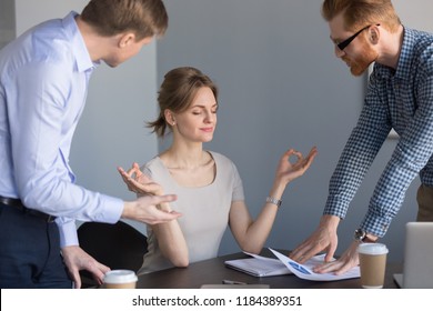 Calm Happy Businesswoman Meditating In Office Ignoring Not Listening To Colleagues, Funny Female Boss Practicing Yoga At Stressful Job Keeping Mental Emotional Balance, No Stress At Work Concept