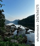 Calm Jordan Pond reflecting the tops of Bubble Mountain in Acadia National Park