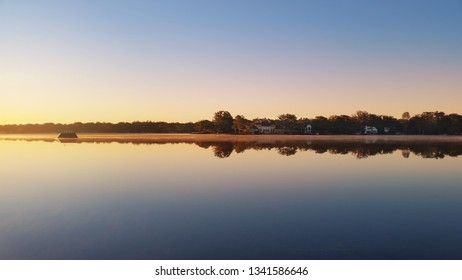 A Calm Lake In The Morning At Sunrise Behind Rollins College In Winter Park Florida