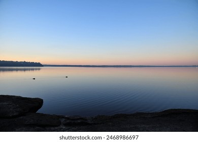 calm lake shore with morning glow - Powered by Shutterstock