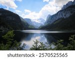 Calm lake Vorderer Gosausee with the Dachstein glacier in the background.