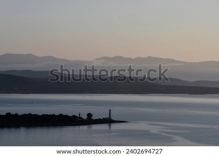 a calm lighthouse dawn on a gray morning