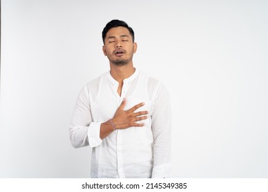calm man with chest hands while feeling comfortable and relieved