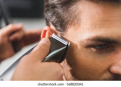 Calm Man Getting Haircut By Machine