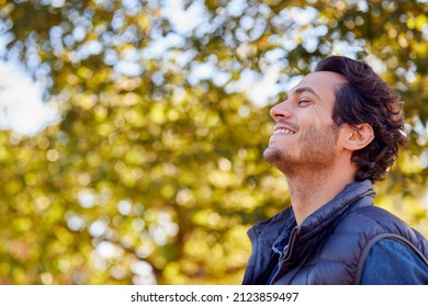 Calm Man Outdoors Relaxing And Breathing In Deeply In Autumn Park - Powered by Shutterstock