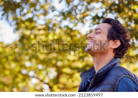 Calm Man Outdoors Relaxing And Breathing In Deeply In Autumn Park
