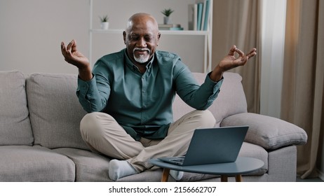 Calm Mindful Old 60s Business Man Break Sit At Home On Couch Meditating Breathing Exercise Feel No Stress Relief Relaxing After Work Problem Senior Mature African Male Practicing Yoga Peaceful Mind