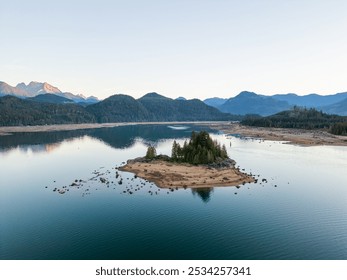 Calm morning light illuminates Stave Lake, surrounded by mountains and lush forested shores in Mission, British Columbia, Canada, creating a serene and peaceful natural landscape. - Powered by Shutterstock