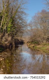 A Calm Mountain River (Ladonas) Flows Through The Mountainous Terrain On A Sunny, Winter Day (prefecture Arcadia, Greece)