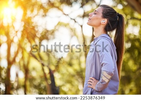 Calm, music and fitness person in nature for mental health, wellness and breathing, forest trees and fresh air. Mockup, sports and athlete woman thinking or listening to audio for running inspiration