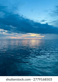 Calm Ocean at Sunset with Clouds