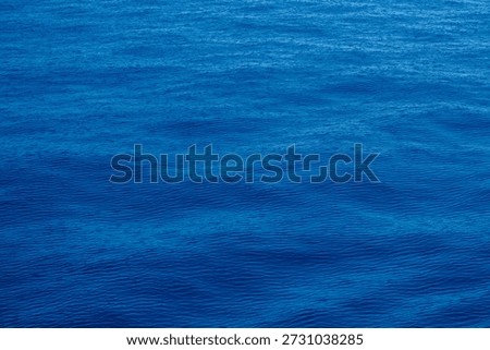 Calm ocean surface in full frame as backdrop and background