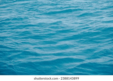 Calm ocean waves creating harmonious patterns. The tranquil waters form rhythmic and soothing designs, showcasing the natural symmetry and tranquility found in the gentle movements of the sea.