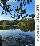 Calm and peaceful lake view in Finland with small rapids.