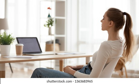 Calm peaceful young woman relaxing in office chair at workplace, tired employee sitting at desk, female student taking break after study, meditating with closed eyes, breathing deep, thinking