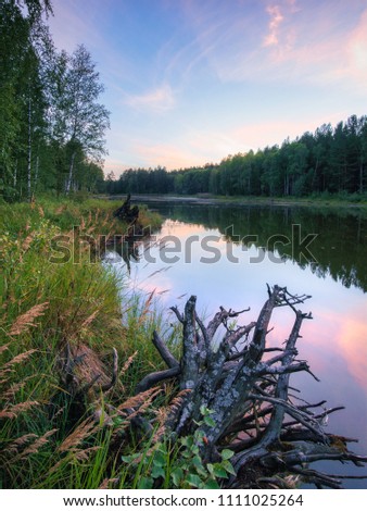 Calm quiet pink sunset on the lake. nature of Russia. Ural. Mirror water.
